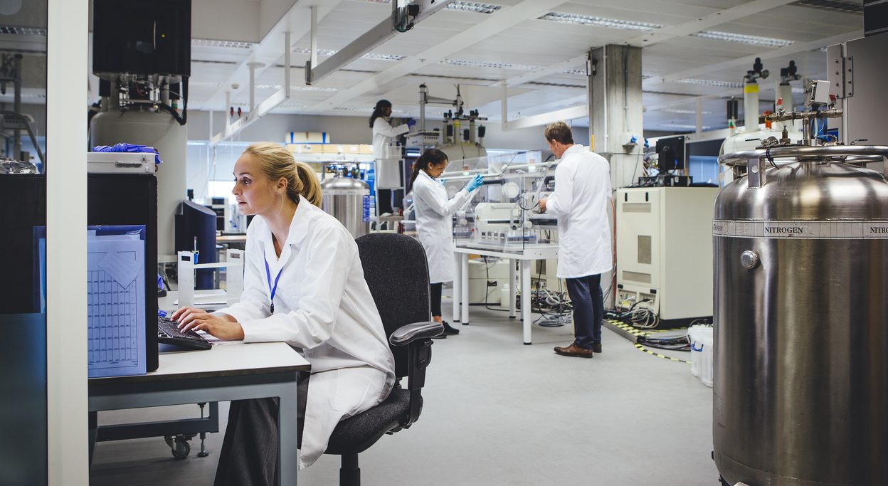 Group of medical science professionals working in a laboratory.