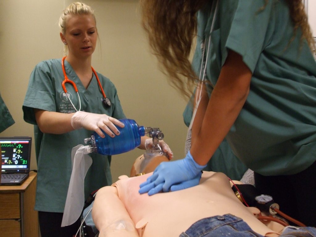 Two campers practicing CPR on SimMan 3G simulation mannequin