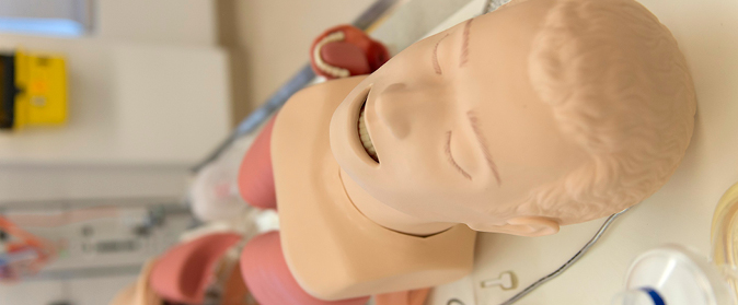 Image of a simulation mannequin laying on a stretcher