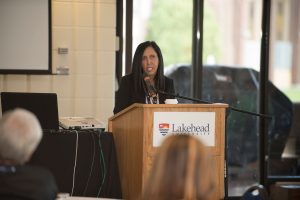 Dr. Carrie Bourassa at 2017 NHRC podium