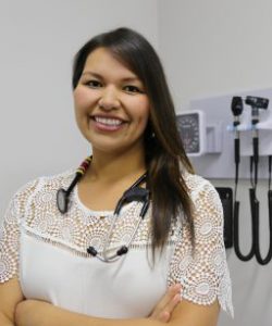 Photo of Dr. Becky Neckoway in a doctor's office with a stethescope around her neck.