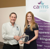 Photo of Dr. Sarah McIsaac receiving an award, shaking hands with the NOSM Associate Dean, Dr. Roger Strasser.