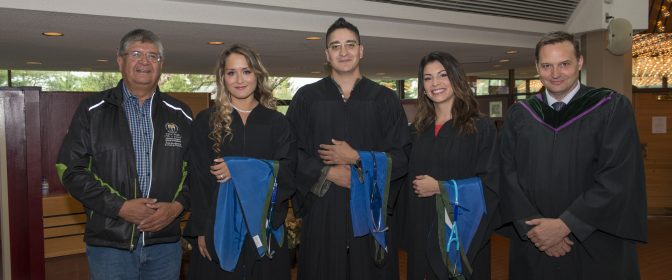 Photo of three Indigenous MD Graduates with an Elder and a NOSM Associate Dean on graduation day.