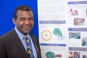 Dr. Emmanuel Abara with poster presentation 