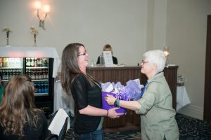 Dr. Penny Moody-Corbett giving a gift to NHRC organizer, Lyne Morvan, NOSM at Laurentian Research Coordinator 