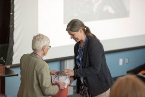 Dr. Penny Moody-Corbett giving a gift to 2015 NHRC presenter