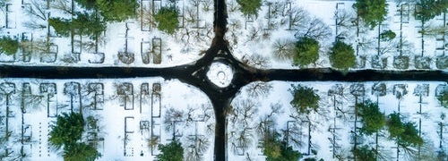 Roundabout with four roads leading in different directions amoung snowy fields with trees