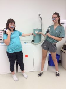 Two campers wearing nose clamps and pose with CO level testing apparatus