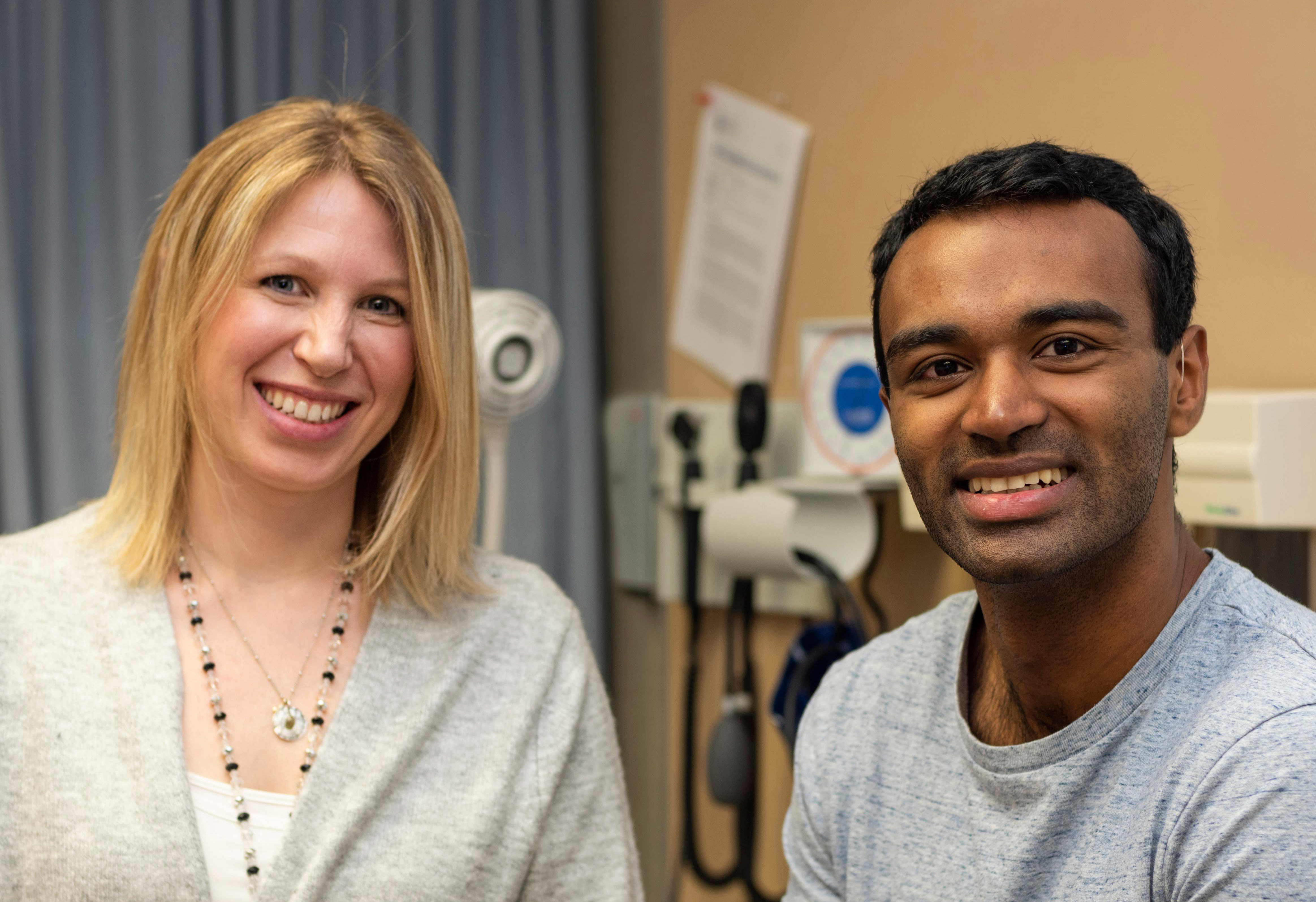 Photo of female and male NOSM medical students in a doctor's office.