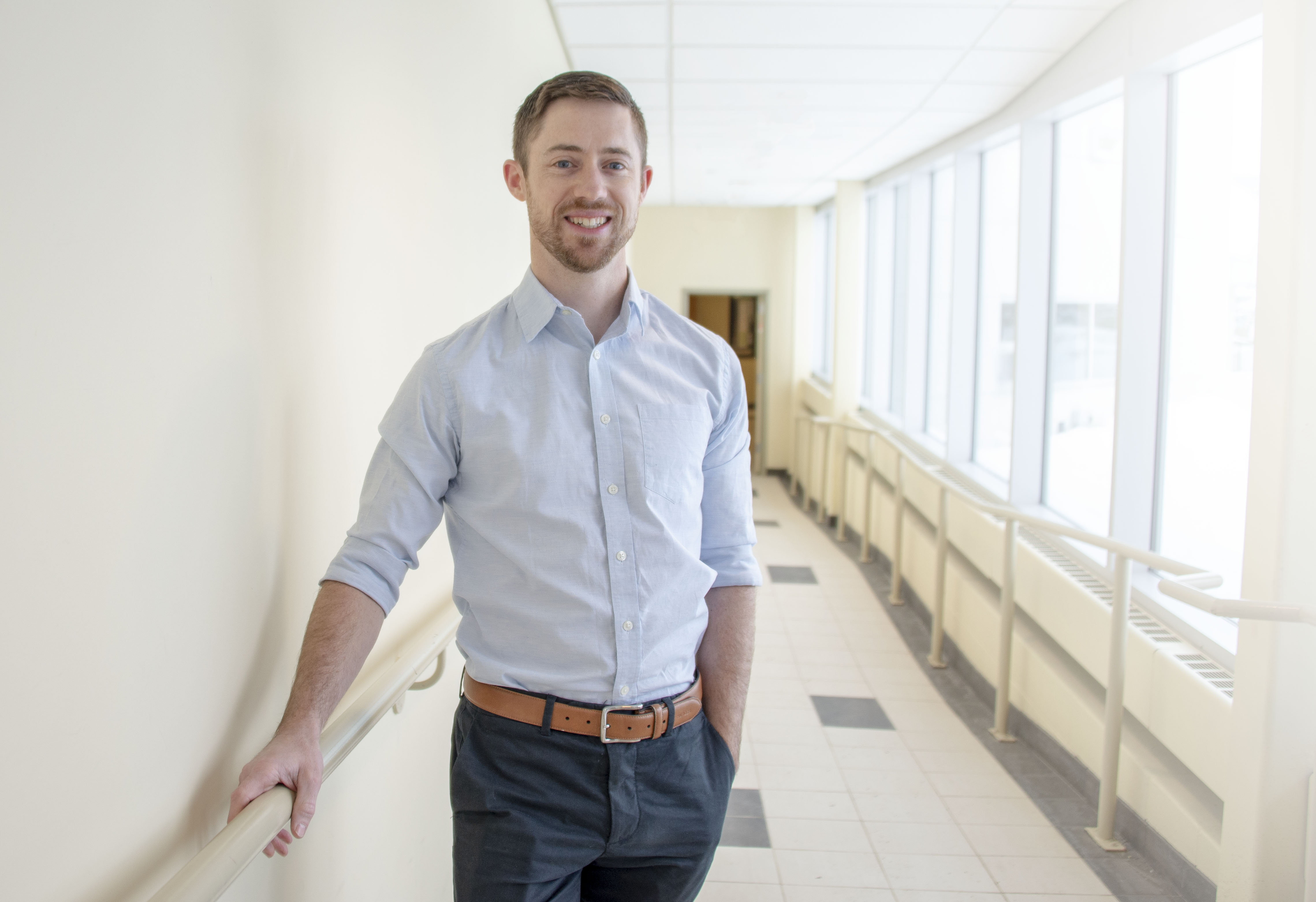 Photo of Dr. Robert Ohle in the hallway of the medical school building in Sudbury.