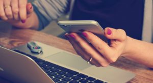 woman learning on laptop and mobile device