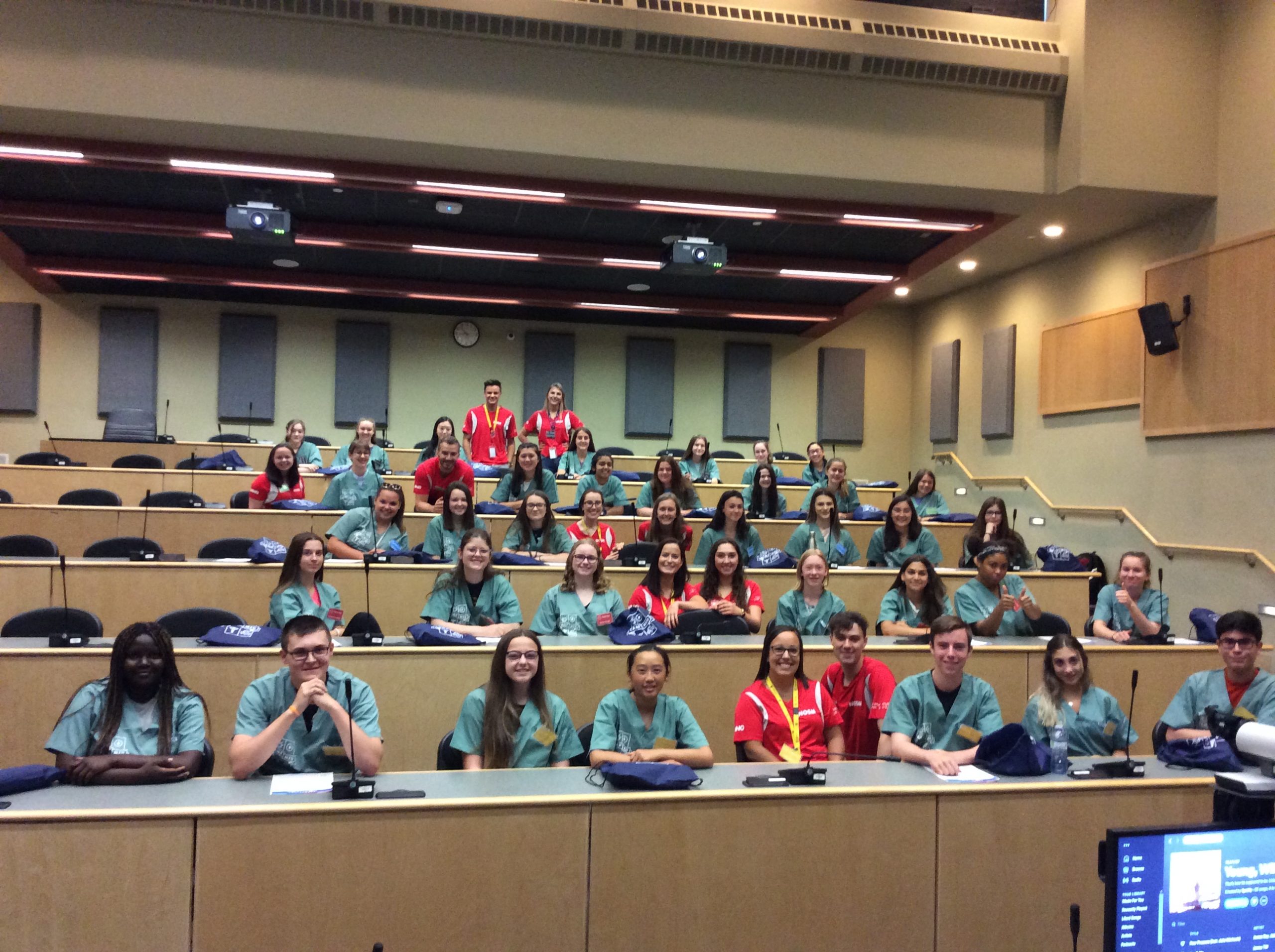 Group shot of campers and team leads in lecture style classroom in Sudbury.