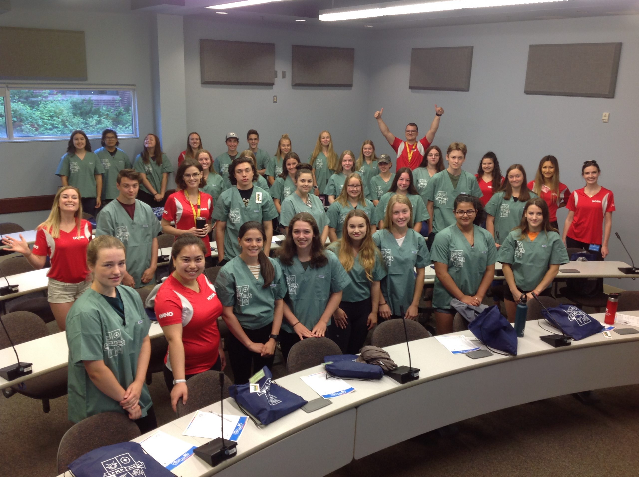 Group shot of campers and team leads in lecture style classroom in Thunder Bay.