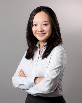 Dr. Christina Hao is smiling with arms crossed, wearing a white collard shirt 