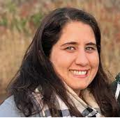 Dr. Bakovic is smiling wearing a checkered scarf