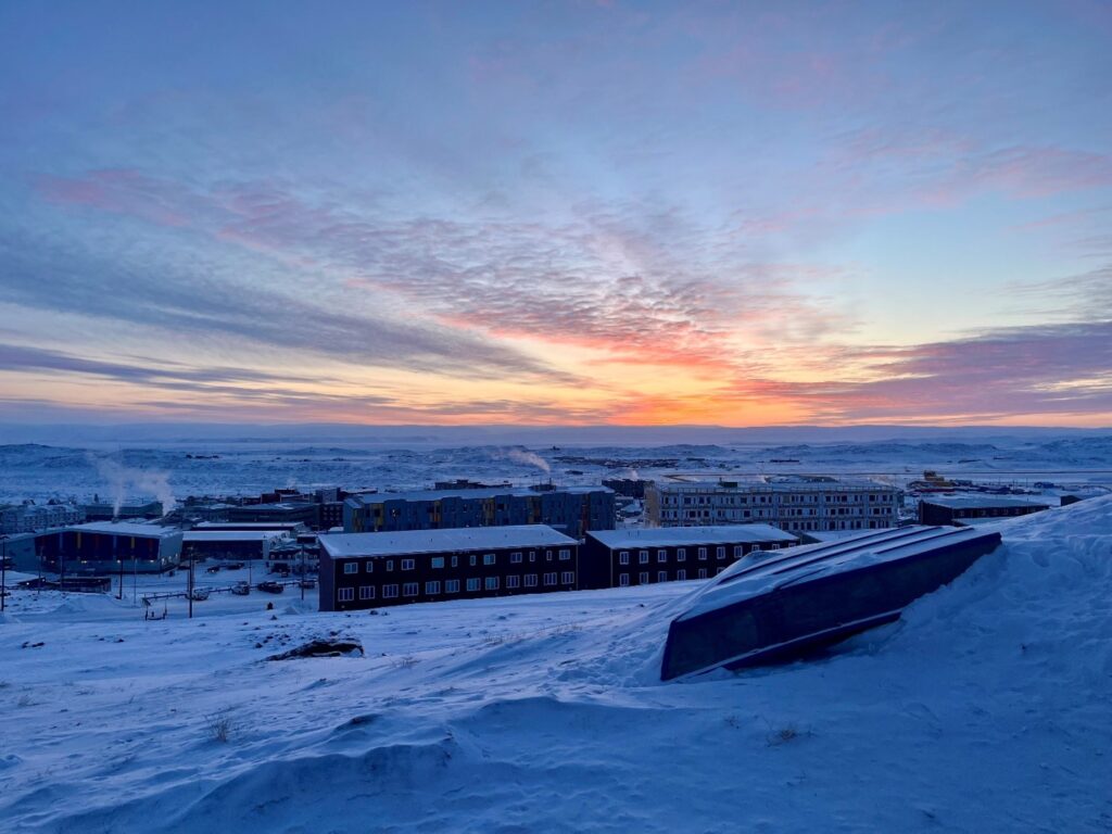 Sunset overlooking snow covered buildings in Nunavut