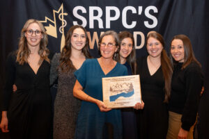 students of the rural generalist program pose for a photo at an award ceremony with Dr. Frances kilbertus holding a certificate. 